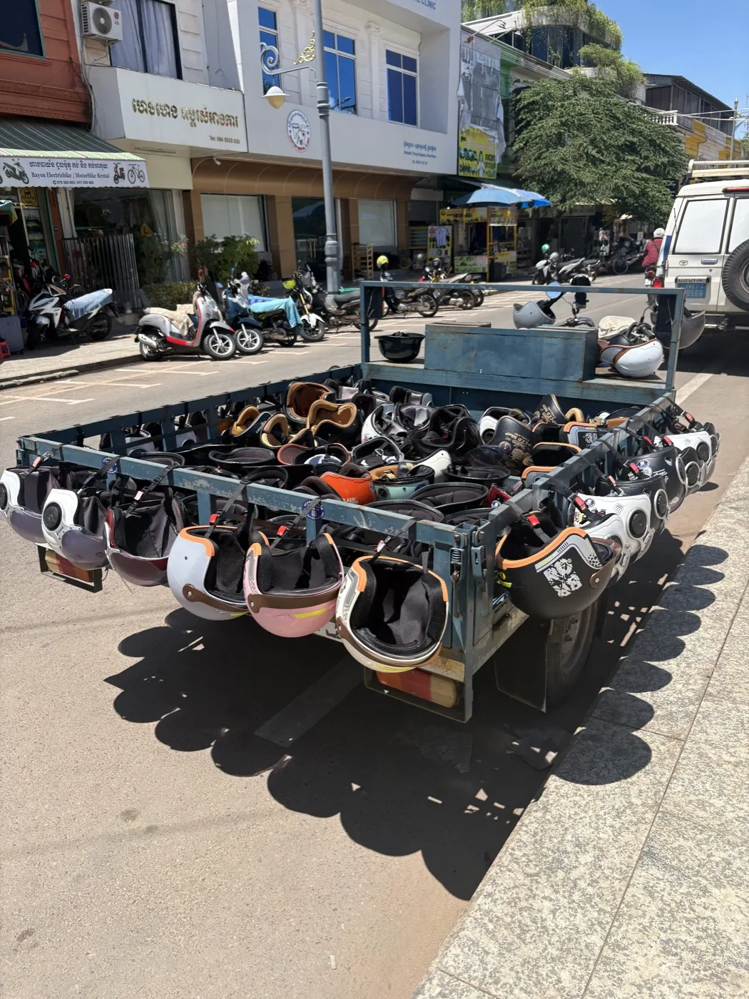 Close-up of helmet cart with dozens of black helmets stacked on the truck bed