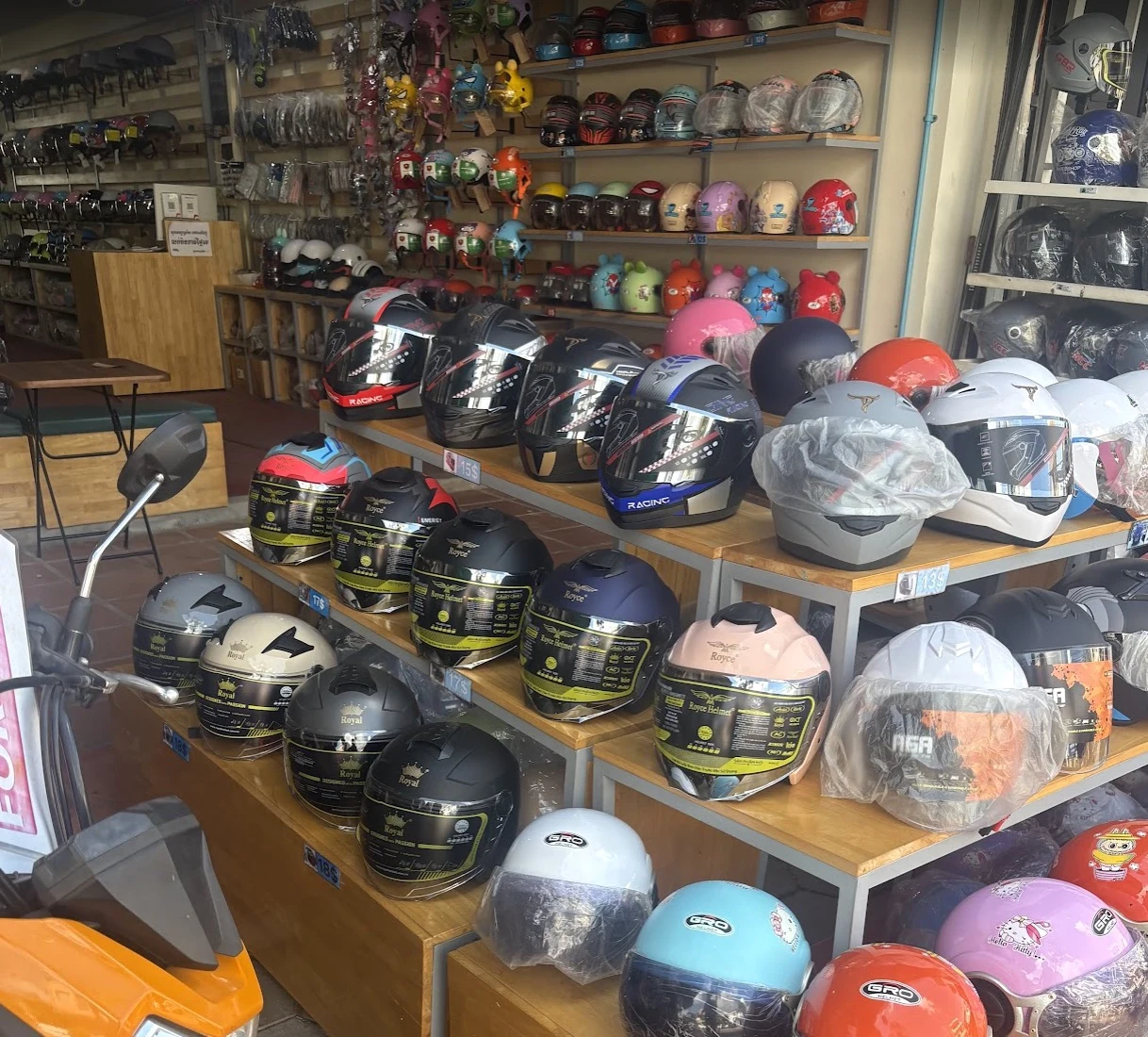 Interior of a large Cambodian motorcycle helmet shop with hundreds of helmets on shelves
