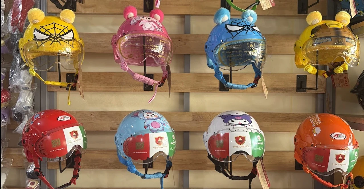 Display board of children's superhero and cartoon-themed motorcycle helmets