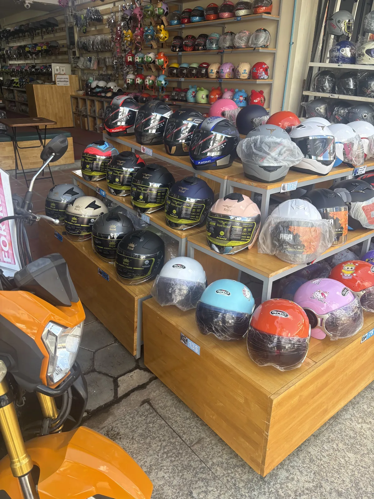 Helmet shop display with many child and adult motorcycle helmets