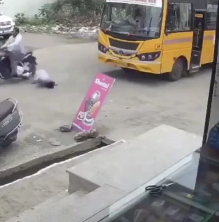 Motorcycle crash near a bus at a road junction