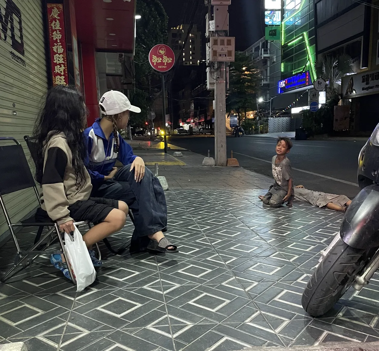 Street-level outreach with a child and family at night in Cambodia