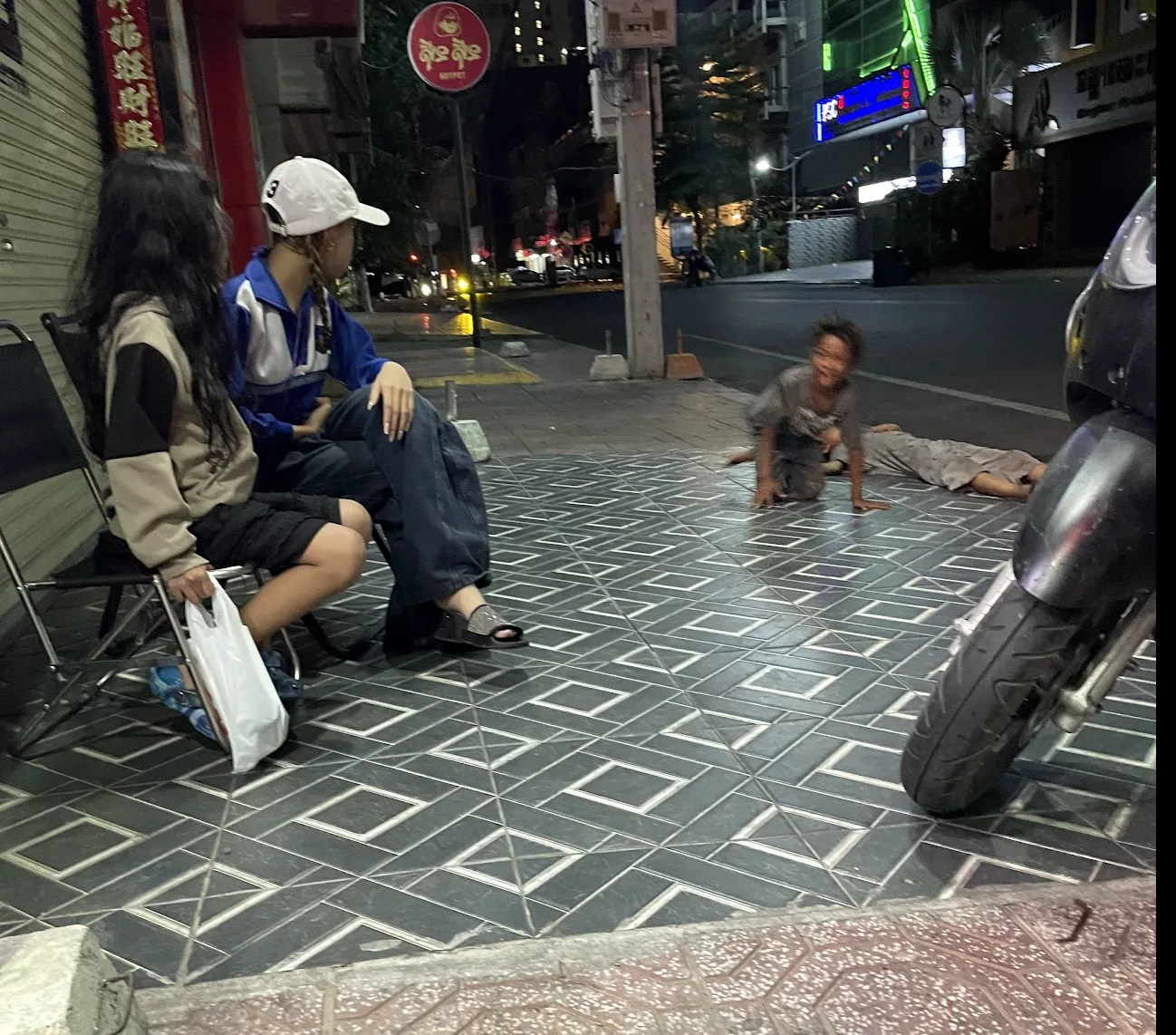 Community engagement with families on a Cambodian street at night