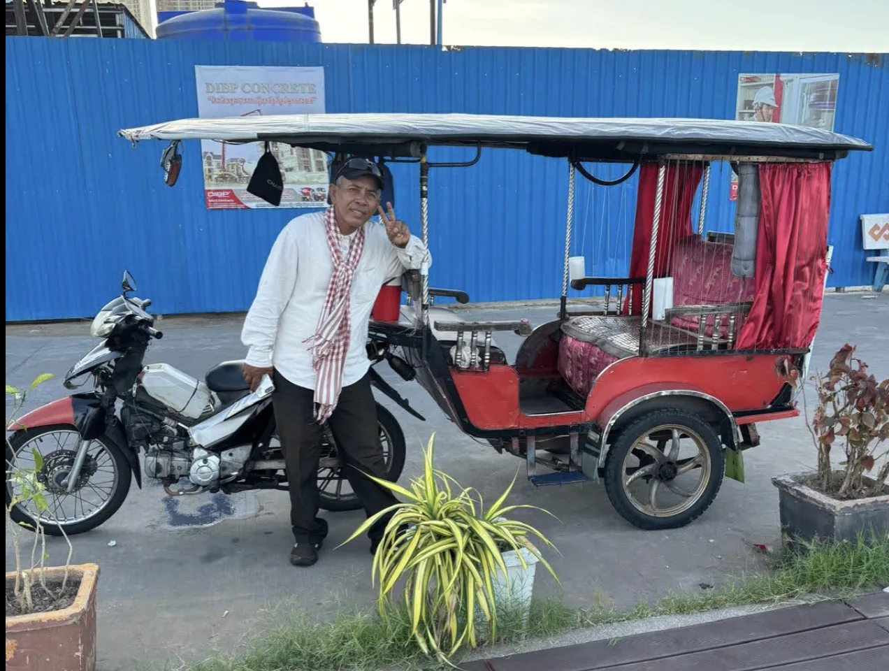 Tuk-tuk with passengers in a Cambodian community
